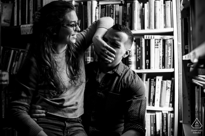 Capitol Hill, Washington DC Pre Wedding Photoshoot while The couple is laughing in a bookstore 