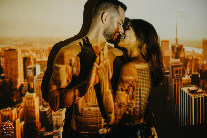 Photo by: <a href="https://www.wpja.com/photos/diamond-award-top-wedding-engagement-photographer/2621892">Heloisa Todescatt - Assis Chateaubriand Paraná Assis Chateaubriand portrait e-session with image of city projected on the couple
