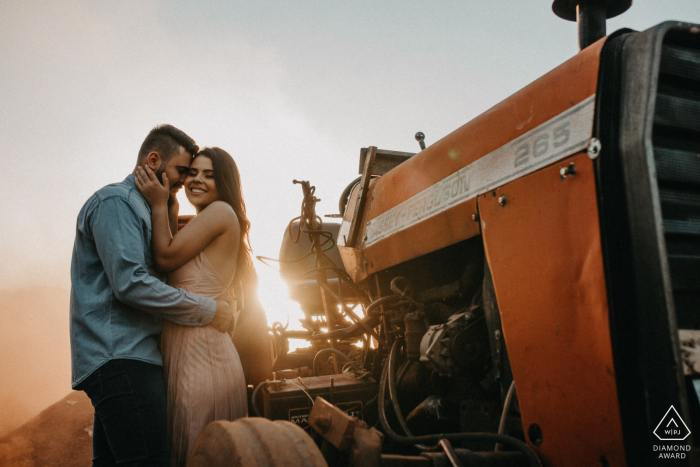 Photo by: <a href="https://www.wpja.com/photos/diamond-award-top-wedding-engagement-photographer/2621893">Heloisa Todescatt - Assis Chateaubriand Paraná Assis Chateaubriand environmental engagement e-session with a tractor at a farm