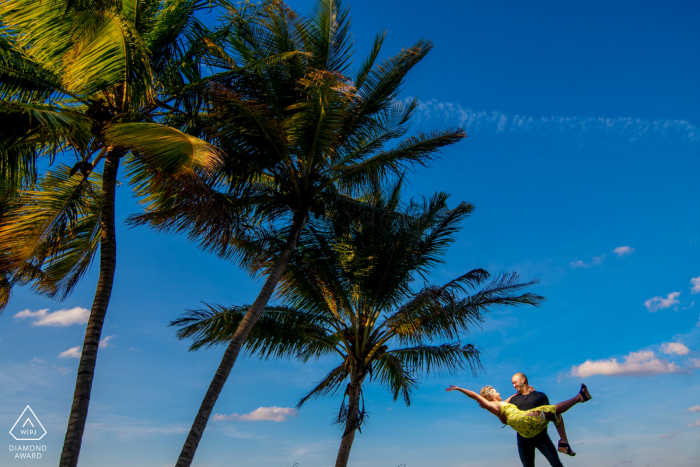 Photo by: <a href="https://www.wpja.com/photos/diamond-award-top-wedding-engagement-photographer/2622803">Alexis Rodriguez Montalvo - Sabana Grande St Regis Hotel, Rio Grande portrait e-session Using the Palm Trees and action to create composition