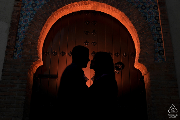 Granada, Spain portrait e-session with dark tones, silhouettes and a lit archway