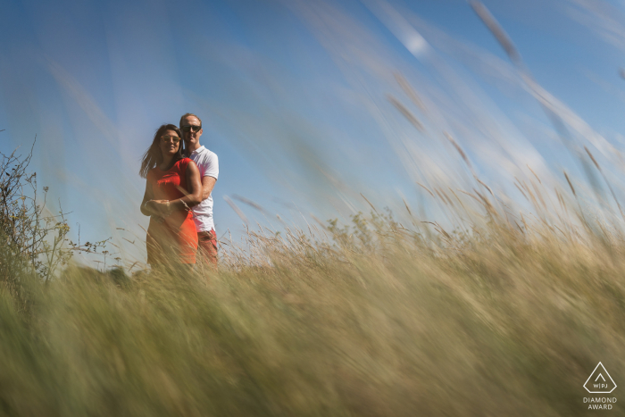 Golf du Morbihan, France environmental engagement e-session in the tall grass field, shot from a low angle Golf du Morbihan, France environmental engagement e-session in the tall grass field, shot from a low angle