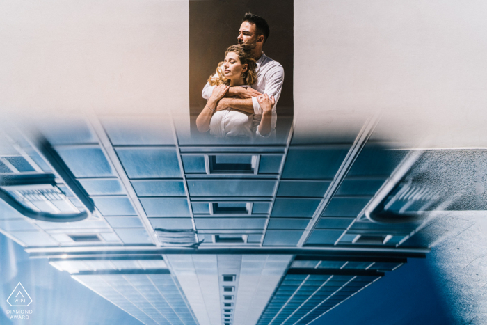 True Love Pre-Wedding Portrait Session in Naples illustrating a couple below reflected towering buildings