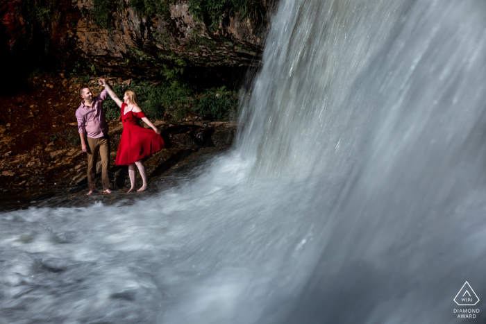 Wisconsin couple e-shoot at Willow River Falls dancing by the waterfall