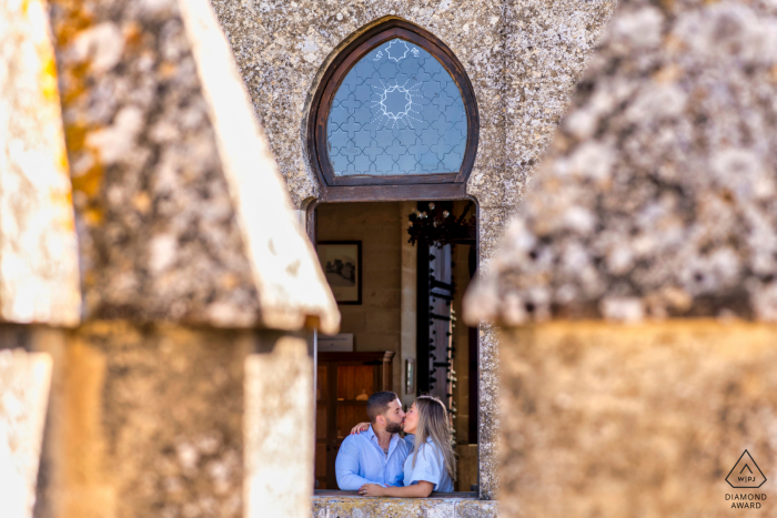 Cordoba, Spain couple e-shoot at the Castillo de Almodovar del Río in a window opening