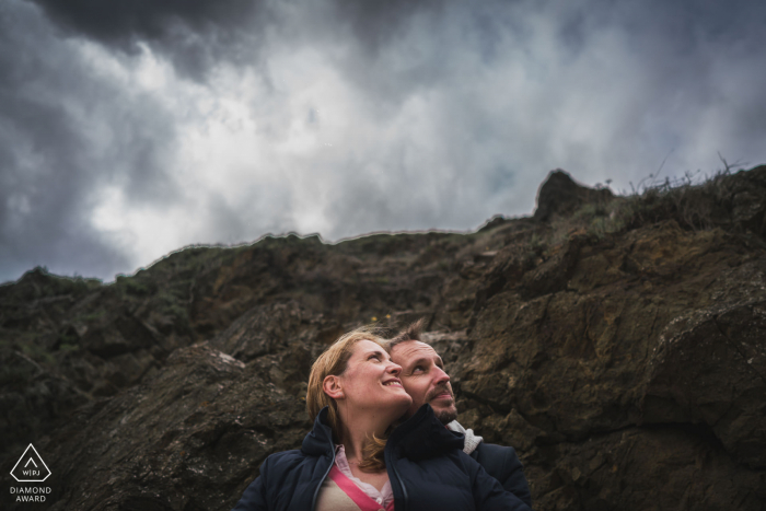 Planguenoual, Frankreich Paar-E-Session mit Liebenden, die auf die Wolken am Himmel über den Hügeln schauen