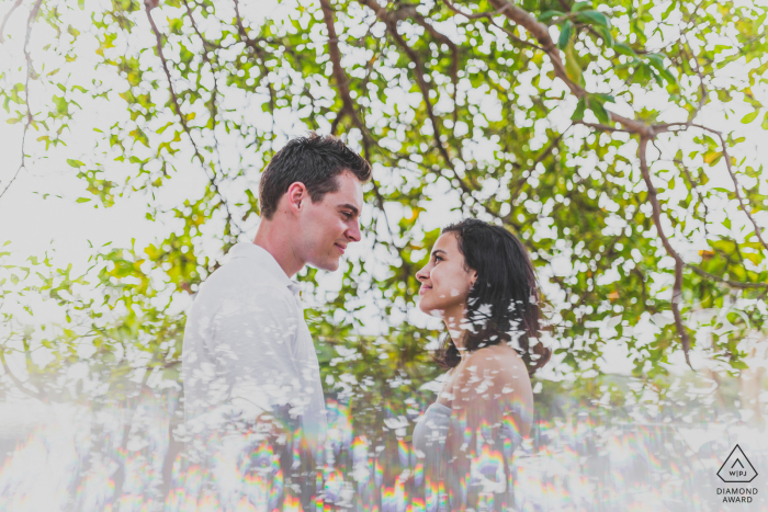 Salvador couple e-session in the trees while they are both looking at each other