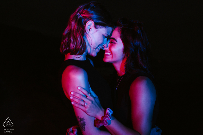 Malibu couple posturing for an engagement image while the photographer is Getting creative with light after sunset