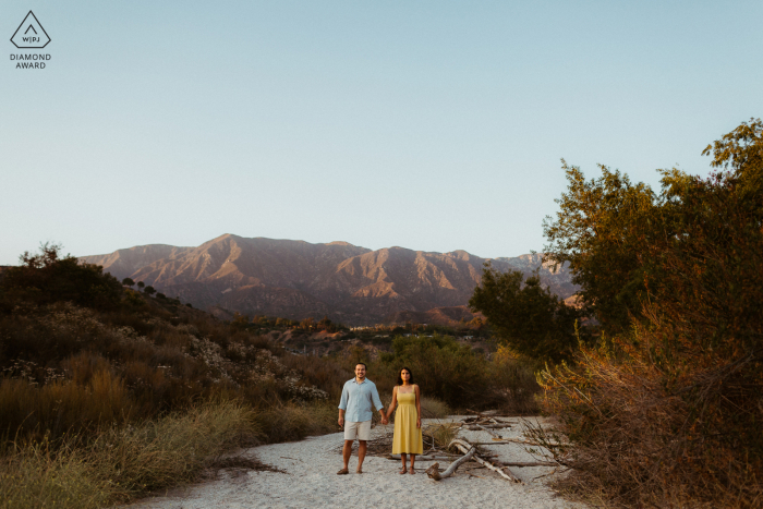 Pasadena bride and groom to be, posing for a pre-wedding engagement photo shoot in the middle of a nature scene