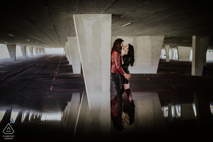 Essen bride and groom to be, modeling for a pre-wedding picture at the Zeche Zollverein Coal Mine Industrial Complex parking structure Essen bride and groom to be, modeling for a pre-wedding picture at the Zeche Zollverein Coal Mine Industrial Complex parking structure