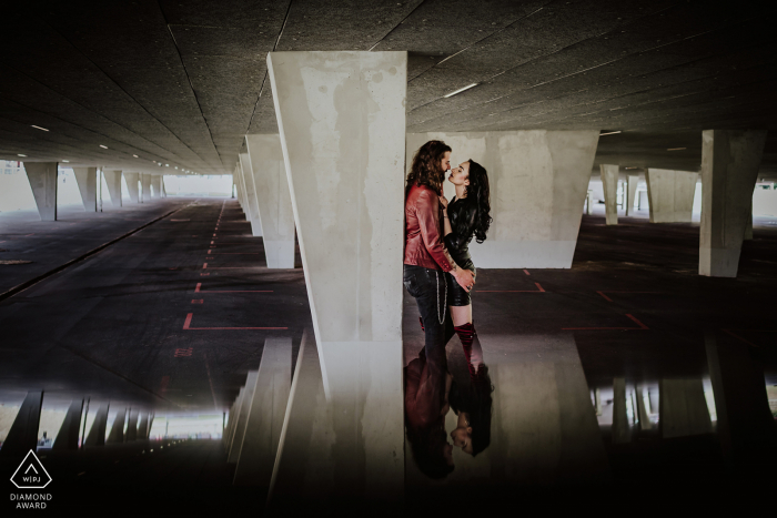 Essen bride and groom to be, modeling for a pre-wedding picture at the Zeche Zollverein Coal Mine Industrial Complex parking structure