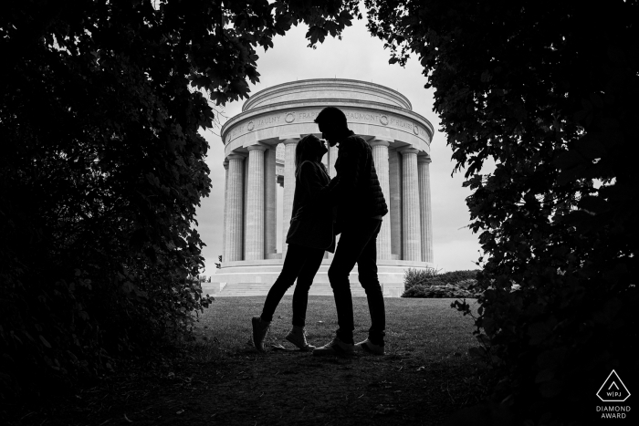 France bride and groom to be, modeling for a pre-wedding picture at Montsec American Monument showing A silhouette couple like a rock