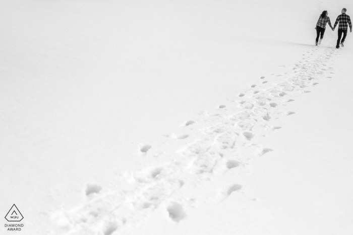 Squaw Valley Lake Tahoe outside environmental couple prewedding photoshoot showing footprints in the fresh winter snow Squaw Valley Lake Tahoe outside environmental couple prewedding photoshoot showing footprints in the fresh winter snow