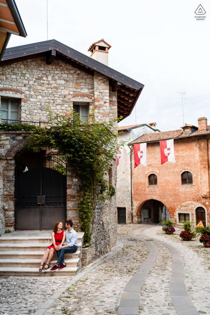 On location Cividale del Friuli, Udine, IT couple engagement portrait shoot while Sitting on the stairs