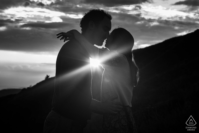 Honeck environmental couple pre wedding image session with A kiss at sunset on the mountain