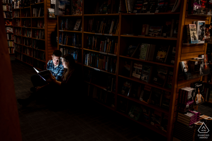 Minneapolis pre-wedding photo-session at a library as the Couple reads together Minneapolis pre-wedding photo-session at a library as the Couple reads together