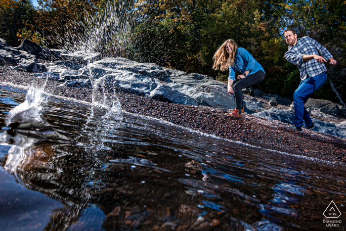 Pre-wedding photo-session in Duluth, Minnesota by the water as the Couple skips rocks