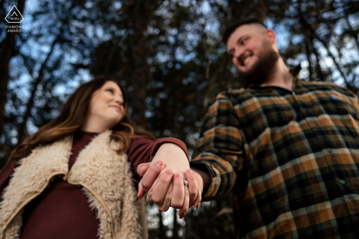 Great Smoky Mountains, TN Portrait créatif ludique créé alors que le couple montre la bague de fiançailles