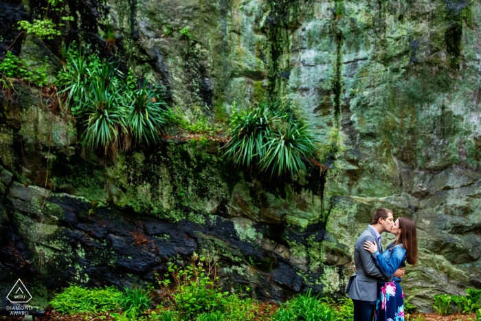 Scenic Fort Tyron Park, NYC engagement picture below the epic rock cliffs and trees