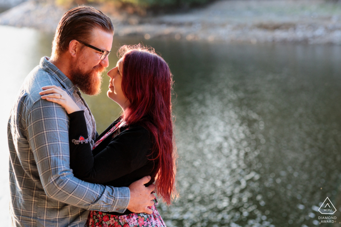 Scenic  Val De La Mare, St Ouen, Jersey engagement image showing the couple embrace by the reservoir