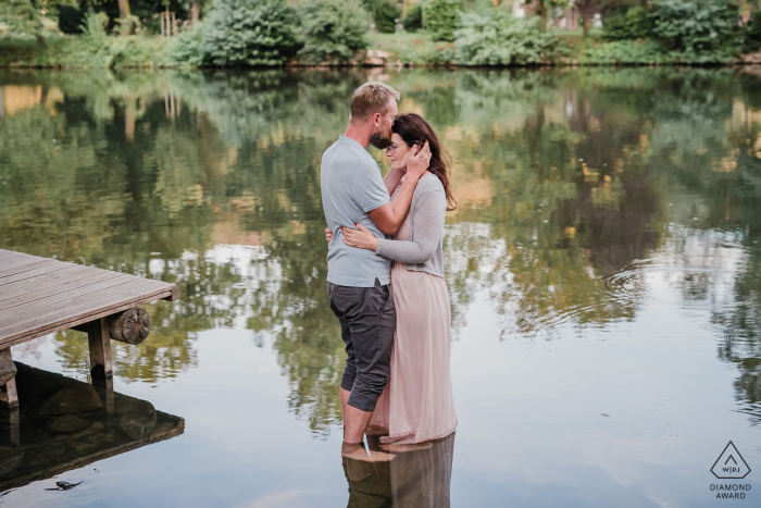 A Germany Wedding, Elopement, and Engagement Photographer created this artistic, adventurous portrait of this Witten couple embraced in the lake