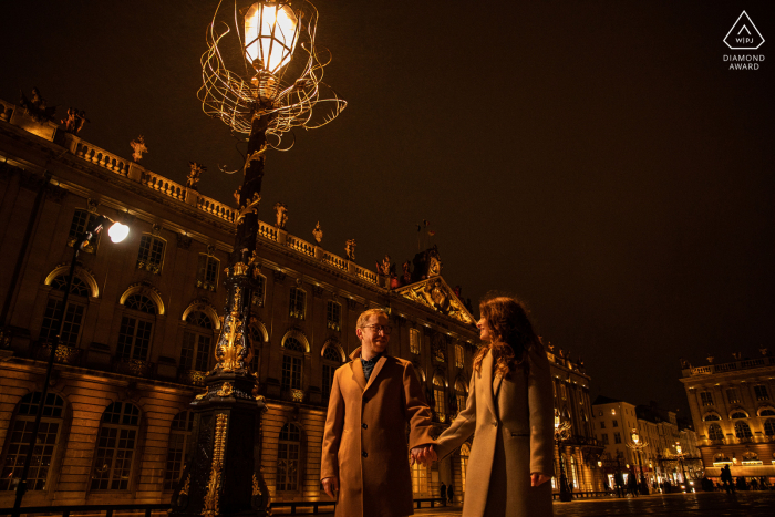 A Vosges Wedding, Elopement, and Engagement Photographer created this artistic, night portrait of this Nancy couple in France depicting them walking through a city at night