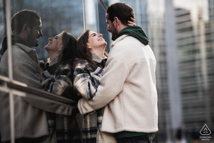 Paris post proposal portraits from a France couple engagement session in the city using building glass for reflections