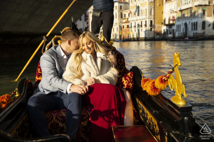 Rialto Bridge post proposal portrait photos of a happy Venice couple during a Gondola ride on the waters of Italy and in the sunshine