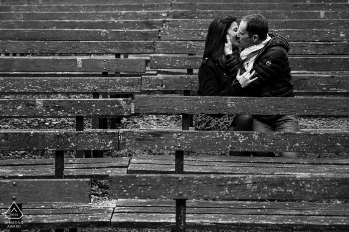 Nancy Engagement Photos. Meurthe-et-Moselle couple posing and kissing on old bleacher seats