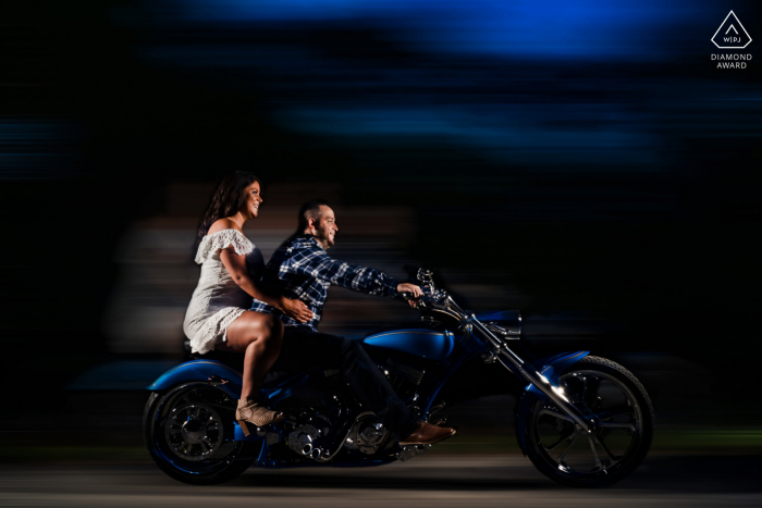 Ein Save-the-Date in Lancaster, PA. Holtwood Dam Porträt eines Paares, das in der Abenddämmerung mit seinem Motorrad unterwegs ist