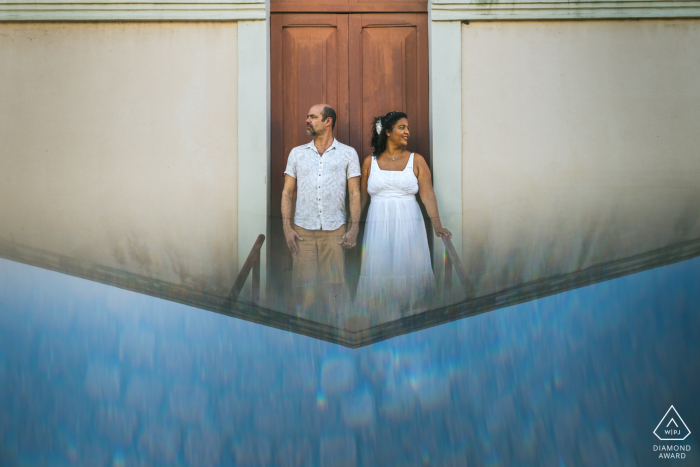 An after the wedding proposal engagement picture session in Maceio, Brazil showing a couple holding hands with a prism reflection An after the wedding proposal engagement picture session in Maceio, Brazil showing a couple holding hands with a prism reflection