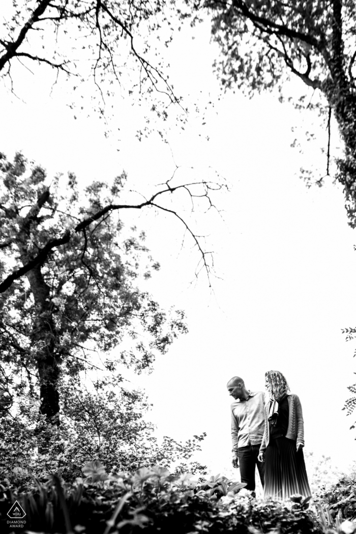 A newly engaged Tarn couple poses in the great outdoors for a France engagement announcement portrait that was an Original shot from below in BW