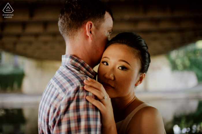 San Antonio couple poses for fun portraits at the Riverwalk to announce their engagement with the girl looking at camera 