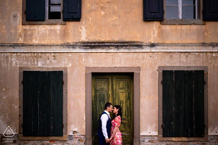 A newly engaged Collio couple poses for some Love on the door during a Friuli Venezia Giulia engagement announcement portrait