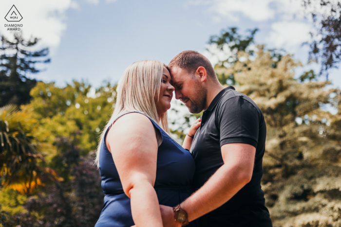 A Metz modern couple forehead to forehead for announcement portrait of their Jardin Botanique engagement