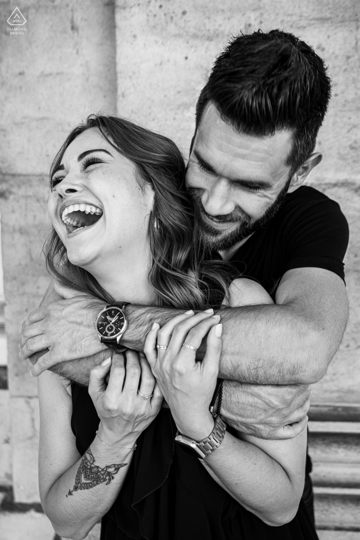 A Nancy modern couple poses while Just laughing for an announcement portrait of their Stanislas engagement