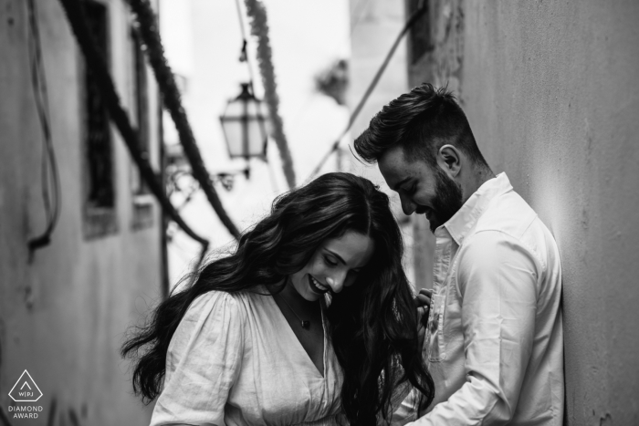 Alfama engagement photography portfolio image with a Lisbon couple enjoying a moment together in one of the oldest and traditional neighborhood