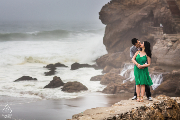 San Francisco announcement of engagement idea with the beach and A warm embrace and kiss by the ocean 