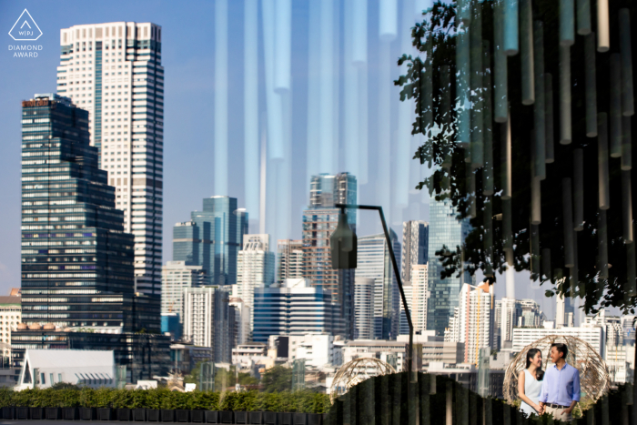 An urban Icon Siam, Bankgkok lifestyle couples shoot on location with the city skyline behind the park setting