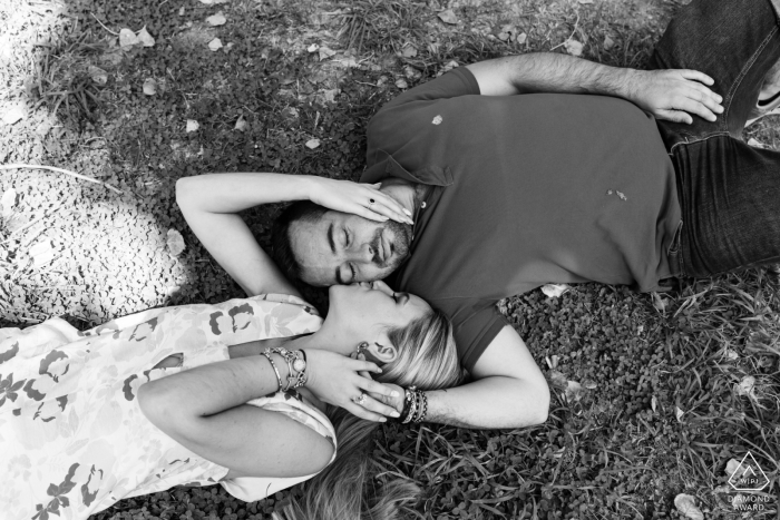 Jaen lifestyle engagement photography of a couple on their backs at Nacimiento del Río San Juan, Castillo de Locubin