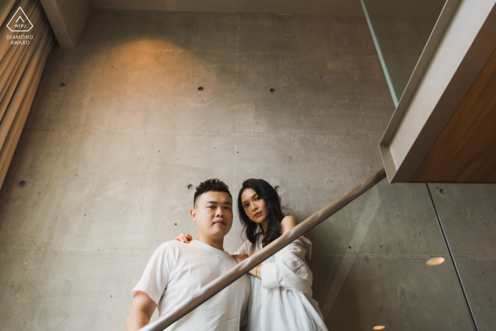 A lifestyle engagement portrait session at the M Social Hotel in Singapore for a couple giving the camera That look