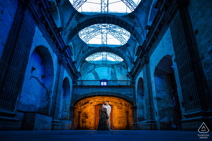 a Guatemala couple posing for a portrait inside the ruins of Convento Santa Clara Las Capuchinas, Antigua, Guatemala Engagement Shoot | The couple portrait inside the ruins of the Convento Santa Clara playing with some white balance in camera