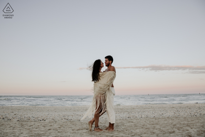 Ravenna Wild Beach, Italia sesión de compromiso para una pareja en la playa con un abrazo en la puesta de sol