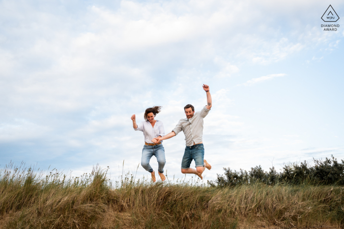 In Estuaire de l'orne, the bride and groom jump from the dune while holding hands with free arms in the air