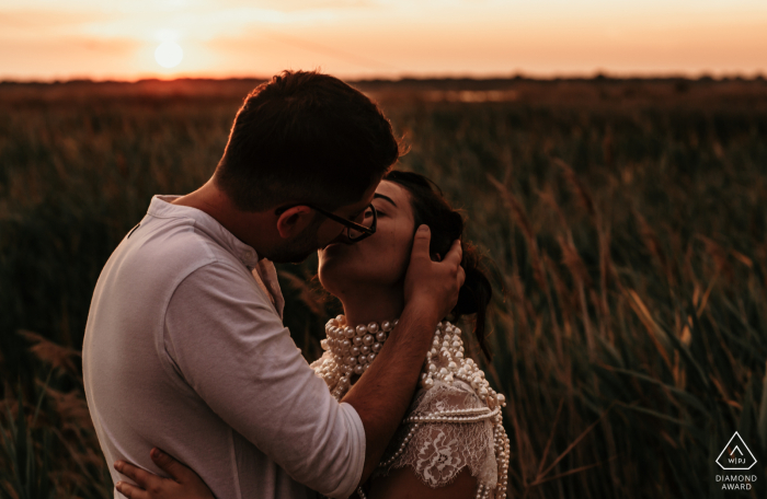 At the Ravenna wild sanctuary, Italy, a kiss at a sunset love session immersed in the nature