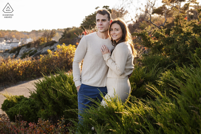 The couple's portrait session evokes peace and warmth, with its gentle hues and tranquil atmosphere The picture session of the couple in Ogunquit, Maine, evokes a sense of peacefulness and warmth through its earthy tones and soft feel