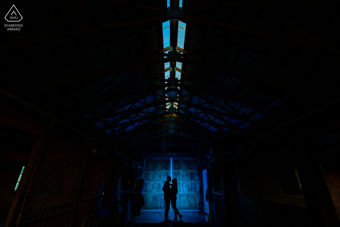 The romantic image of a couple silhouetted and framed by a horse barn door is a classic symbol of everlasting love