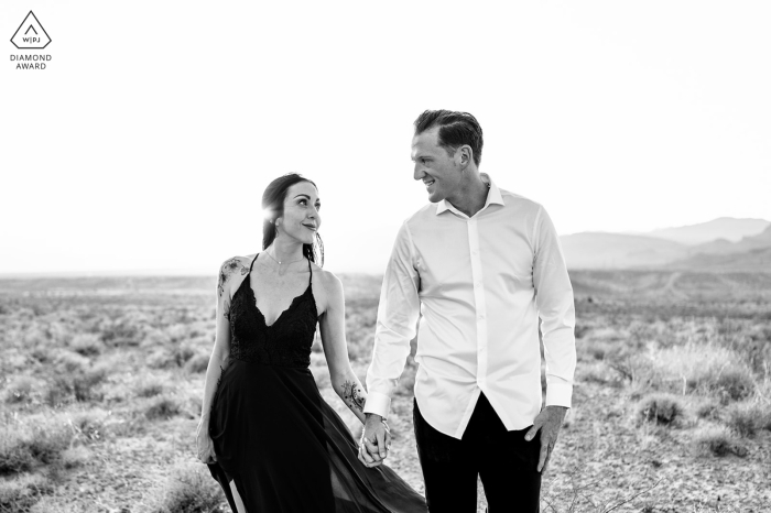 The couple's strong bond and unwavering trust in each other shined through during their BW desert picture session at the Nellis Dunes A couple celebrated their bond by taking an intimate photoshoot in the desert's sand dunes