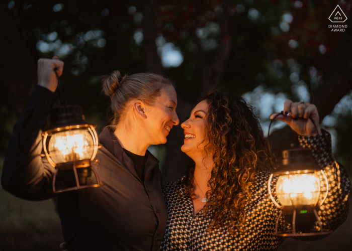 A pre-wedding portrait session was illuminated by two lanterns against the backdrop of the Arboretum in the low light