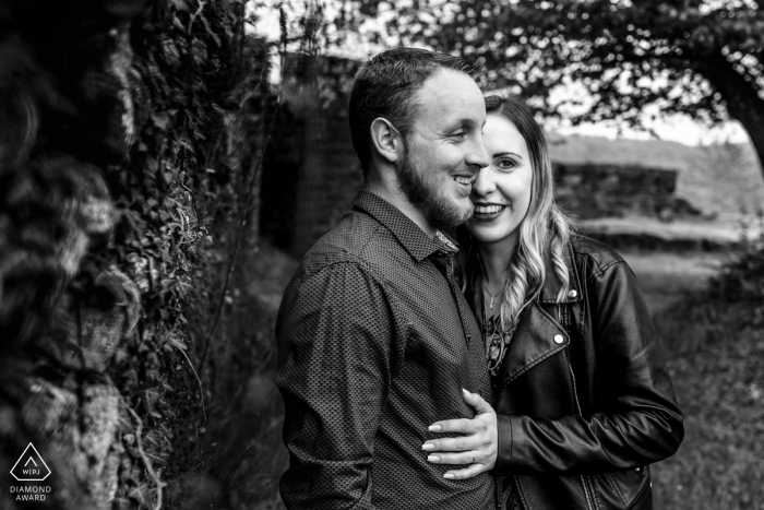 The couple's engagement portrait from the Château de Lutzelbourg in Luxembourg is a beautiful black and white photograph, with the woman subtly standing behind the man